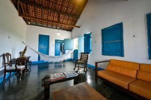 a living room with a couch and a hammock in it at Fazenda Poço das Pedras in São João do Cariri