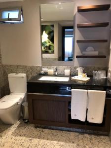 a bathroom with a sink and a toilet and a mirror at Hotel Metropol in Mexico City