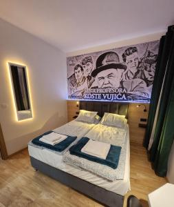 a bedroom with a bed with a poster of a movie at Magazaki Apartments Tešnjar in Valjevo