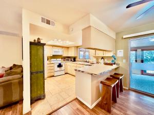 a large kitchen with white cabinets and a couch at Zen Desert, 2BR/2BA Apartment, Private Entrance in Sedona