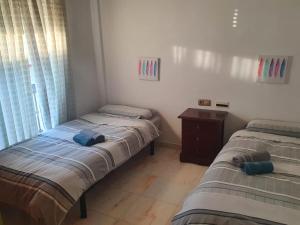 Posteľ alebo postele v izbe v ubytovaní PISO ROCIO + 9 fotografií