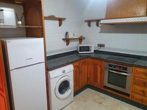 a kitchen with a white refrigerator and a dishwasher at PISO ROCIO in Almonte