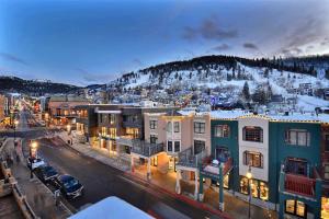 a city at night with a snow covered mountain at Stay Amidst Main Street Park City; Skiing Shopping dining and nightlife Right Out Your Front Door in Park City