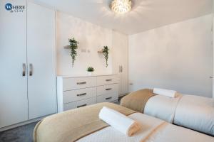 two beds in a bedroom with white walls at Gorgeous 2 bed apartment Durham 