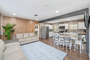 a large living room with a couch and a kitchen at Westville Pines Cabin in Westville