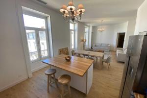 a kitchen and living room with a table and a dining room at Sunny luxury flat in the city centre in Montpellier