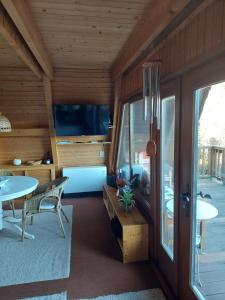 a living room of a house with a table and a window at Haus am See Willingen in Willingen