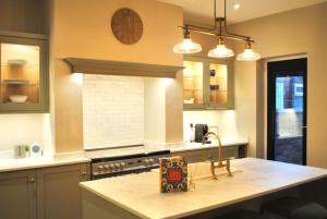 a kitchen with a large clock on the wall at Cosy Renovated House in Warrington in Warrington