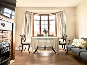 a living room with a table and a couch at Beautiful House in London - Abbey Wood in Abbey Wood