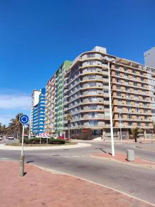 a large apartment building on the side of a street at Tenbury by the beachfront 806 in Durban