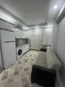 a living room with a couch in a kitchen at 6 şubat apartmanı in Avanos