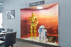 a room with a marvel exhibit with a statue of an astronaut at Galactic Dream: Arcade, Theater, Minigolf, & more! in Garden Grove