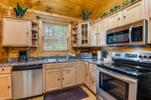 a kitchen with wooden cabinets and a stove top oven at Smoky Bear Cinema in Sevierville