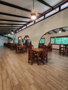 a dining room with wooden tables and chairs at Evergreen Lodge in Tortuguero