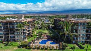 an aerial view of a resort with a pool and palm trees at Kihei's Seaside Siesta: Ocean View Lanai & Pool in Kihei