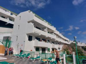 a large white building with people standing in front of it at Francesco House 1509 Monte Paraiso Puerto Rico in Mogán