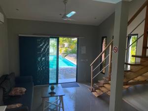 a living room with a view of a swimming pool at Residence Las Dos Palmas in Las Terrenas