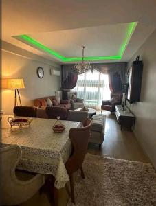 a living room with a table and a green light at شقة انيقة مطلة على البحر in Istanbul