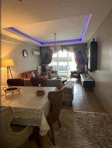 a living room with a table and a couch at شقة انيقة مطلة على البحر in Istanbul