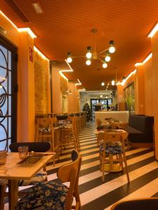 a restaurant with tables and chairs in a room at Bubaqia House - Suites Boutique in Granada