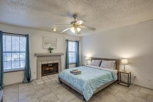 a bedroom with a bed and a fireplace at Inviting Dallas Condo Less Than 2 Mi to NorthPark! in Dallas
