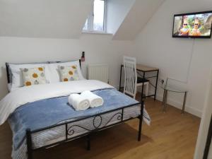 a bedroom with a bed with two towels on it at Eagle Way Apartment in Peterborough