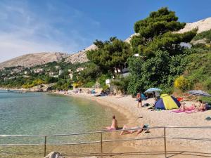 a group of people on a beach near the water at Villa Mar - Only 50m To The Beach in Stara Baška