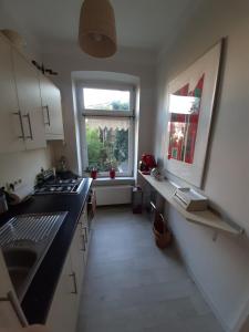 a kitchen with a sink and a window at City-Apartment 1 in Schwerin