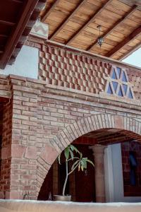 a brick archway with a potted plant in front of a building at Hotel Casa Mixteca in Huajuapan de León