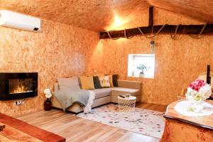 a living room with a couch and a fireplace at Villa Garcia in Terras de Bouro