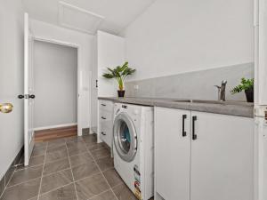 a white laundry room with a washer and dryer at Allendale in Berridale