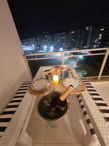 a table with a candle on a balcony with a view at PÉ na Areia com Jacuzzi e Vista Incrível Para MAR! in Guarujá