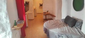 a small room with a bed and a table at Cuevas Althea in Baza