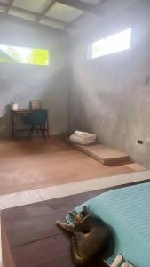 a room with an elephant laying on the floor next to a pool at 2 bedroom family house in Lodge in General Luna