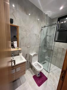 a bathroom with a shower and a toilet and a sink at Malabata hills 3 bedroom in Tangier