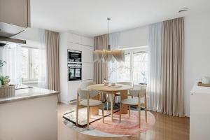 a kitchen and dining room with a table and chairs at Central beautiful modern accommodation near Stockholm City in Stockholm