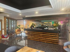 a restaurant with a bar with chairs and tables at ibis Styles Orange in Orange