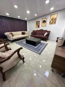 a living room with couches and a coffee table at Meydan Suite Apartments in Trabzon