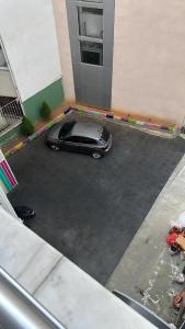 a car parked in a parking lot next to a building at Meydan Suite Apartments in Trabzon