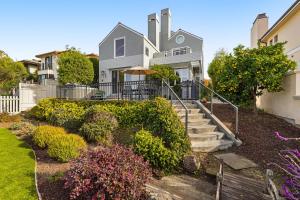 una casa con una valla y algunos arbustos en Harbor Haven en Santa Cruz