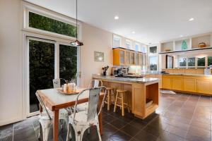 a kitchen with a table and chairs and a table and a counter at Harbor Haven in Santa Cruz