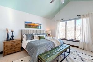 a bedroom with a large bed and a window at Wild Horse Meadows in Eden
