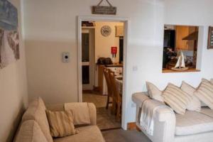 a living room with a couch and a table at The Grockle Hide in Seaton