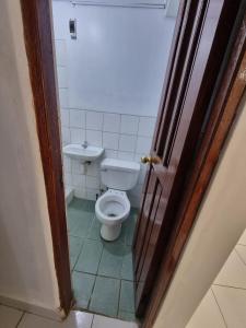 a bathroom with a toilet and a sink at Casa Turismo Terres in Cusco