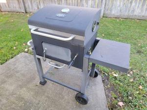 a grill sitting on a stand in a yard at Beautiful Craftsman Style Home w/ Fenced Yard in South Beloit
