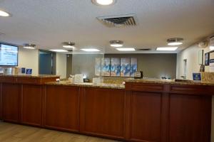 a waiting room with wooden cabinets and a large mirror at Best Western Tallahassee Downtown Inn and Suites in Tallahassee