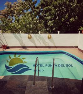 a swimming pool with the hotel punilla del sol at Hotel Punta del Sol in Zipolite