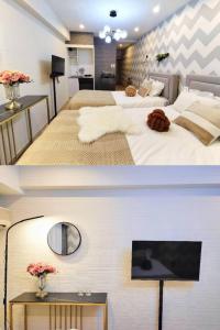 Dos camas en una habitación de hotel con televisión. en G23新宿最中心 東新宿站5分-Shinjuku center 5 mins to Station, Max 3P 新宿 涉谷 表参道 池袋 上野 代代木 银座 原宿, en Tokio