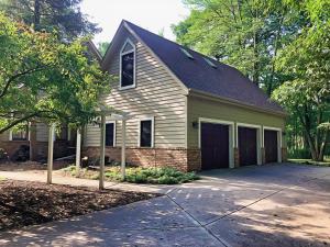 a white house with a garage and a driveway at North Oaks Estate in Blaine