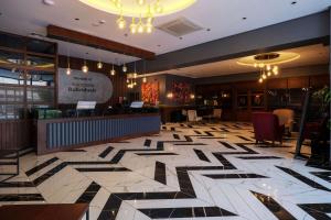 a restaurant with a lobby with black and white tile floors at Nova Vista Deluxe & Suites a Member of Radisson Individuals in Eskisehir